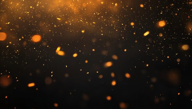 The image shows many golden particles of varying sizes and shapes dispersed against a dark background, creating a sparkly effect.