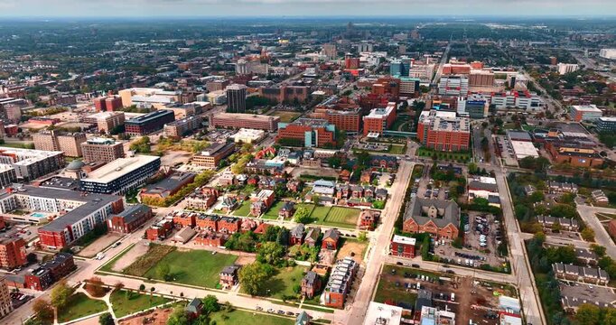 Approaching lovely green residential area with cozy houses. Neighborhoods of modern Detroit uptown, Michigan, USA. Aerial view.