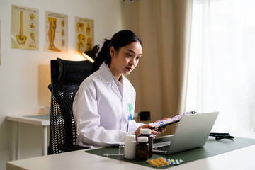 Asian woman doctor working on telehealth consultation