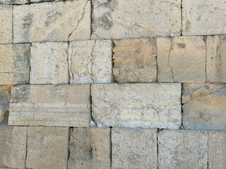 Historic Greek wall of large rectangular stones, perfect aged stone background with strong texture.