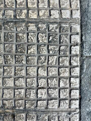 Antique grey mosaic relic tiles with raised textures, offering an ancient and artistic background design.