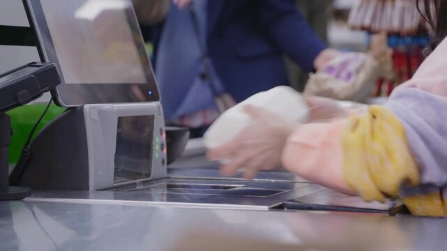 supermarket checkout staff service scanning product in grocery store. scan payment item buy