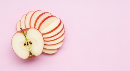 Half Apple with Seeds and Sliced Apple on a Pink Background