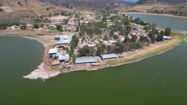 Drone footage flying around restaurants near Valencia Dam in Jalisco, Mexico. A serene and scenic location