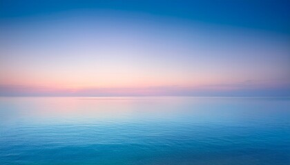 beautiful sunrise over the sea with blurred pastel toned background serene pink and blue sky blending into calm water peaceful natural landscape ideal for wallpapers digital art or tranquil themed