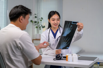 Doctor discussing x-ray results with patient at clinic