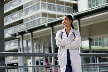Confident Asian woman doctor smiling standing at hospital