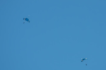 parachutists  descending with blue sky in the background in Salisbury Wiltshire