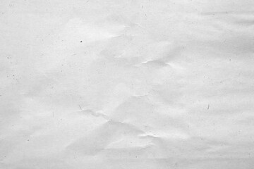 Creased recycled paper with dust and scratches. Grunge background texture