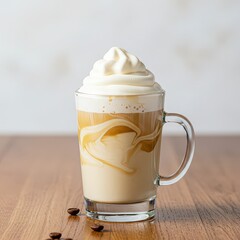 Glass of iced coffee with whipped cream topping on wooden table, rich swirl of espresso and milk, cozy coffeehouse concept, creamy caffeinated beverage for cafe menu or dessert drinks