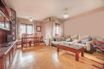 low sofa, glass coffee table, and dining area with simple chairs