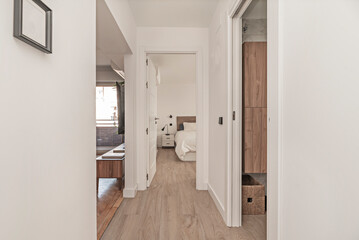 Narrow hallway with invisible integrated storage: pocket doors and drawers under a discreet bench