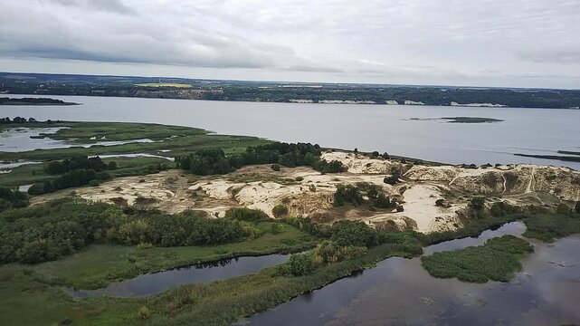 Ancient River Dunes Surrounded By Green Banks Under A Gloomy Autumn Sky.