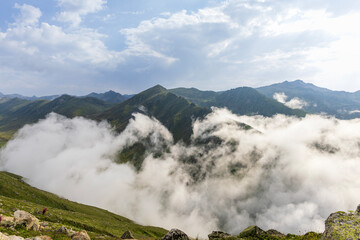 Epic wide angle of majestic mountain peaks surrounded by clouds and drifting fog, creating a dramatic and atmospheric natural landscape. Kackar, Rize, Turkey, 2025