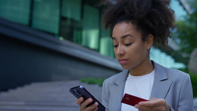 Frustrated woman holding credit card after payment failure