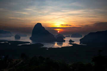 Beautiful and colorful sunrise over the sea. Large rocks in the sea. Dawn in Thailand. Colorful sky...