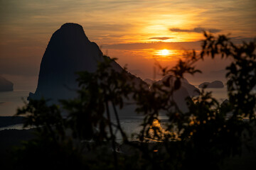 Beautiful and colorful sunrise over the sea. Large rocks in the sea. Dawn in Thailand. Colorful sky in the morning.	
