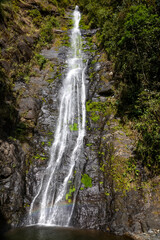 A beautiful mountain waterfall. The water falls into a lake. The waterfall is in Bolivia.