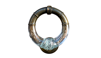 Ornate brass door knocker in a ring shape