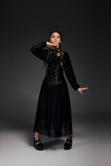 Fototapeta premium Gothic girl in a Halloween costume embodies the spirit of the spooky season