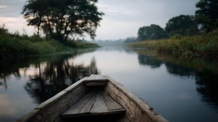 Obraz premium Traditional wooden boat on a serene rural river with peaceful reflections
