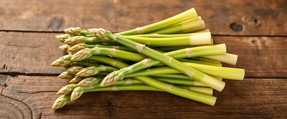 Fresh green asparagus spears bundled together on rustic wooden surface,   clean eating,   still life