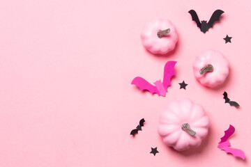 Pink and black paper bats on pastel pink background.