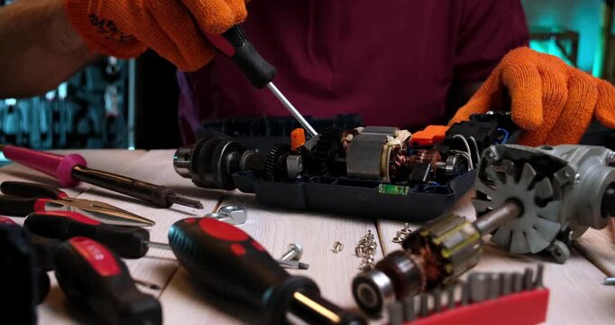 Repair of power tools. A master in a repair shop repairs a power tool High quality 4k footage