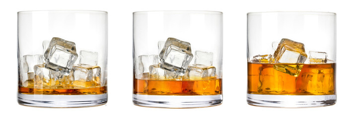 Whiskey glasses with ice cubes on rocks
