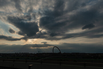 Cloudy sky above the Turin skyline, light and shadow blending on the urban profiles, atmosphere at sunset. Weather forecast for the city suspended between clouds and iconic silhouettes.