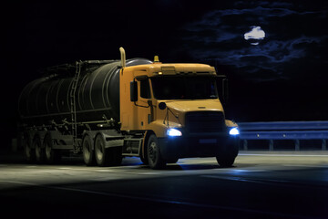 large fuel tanker moves along country road on moonlit night.