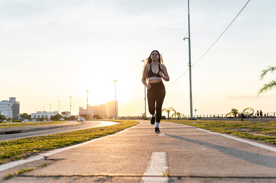 Sportive Latina training outdoors on urban pathway, Asuncion, Paraguay