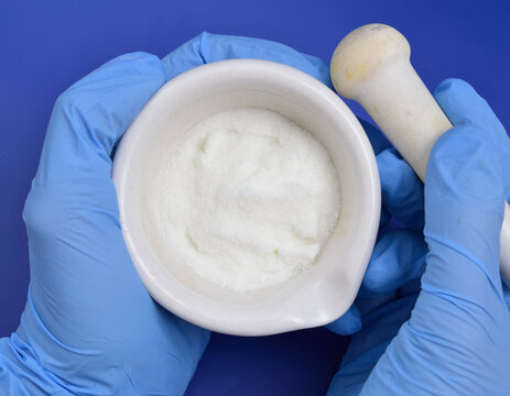 Metronidazole powder on blue background