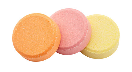 Three colorful effervescent tablets isolated on transparent background, orange pink and yellow fizzy vitamin pills for health and wellness