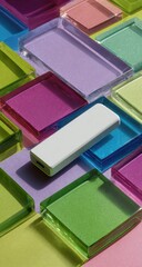 Fototapeta premium White rectangular device on a colorful mosaic of translucent squares