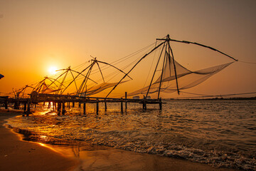 March 25, 2016, in Kochi, India, the iconic Chinese fishing nets stand tall against a glowing...