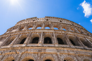 Obraz premium Colosseum, an iconic roman landmark, standing under a bright blue summer sky