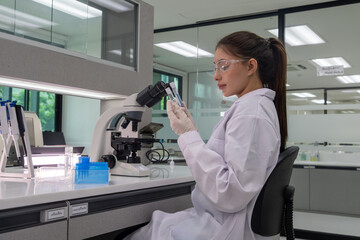 Scientist analyzing samples with a microscope in a modern laboratory setting