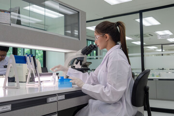 Scientist conducting experiments in a modern laboratory during daytime with advanced equipment and technology