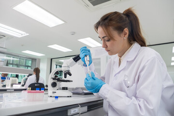 Scientific researcher conducts experiments in modern laboratory during daytime