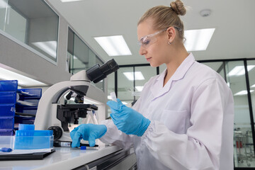 Scientist examines samples using a microscope in a modern laboratory setting