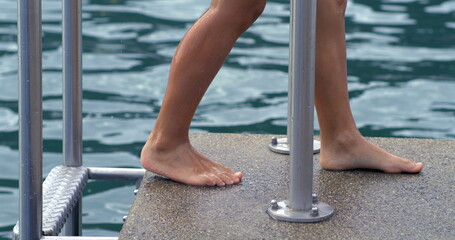 Child exiting the lake via ladder in slow-motion at 800 fps, highlighting the effort and...