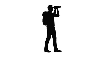 Photographer with camera and backpack captured in a dramatic silhouette