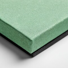 Mint fabric box rests atop a black, textured surface