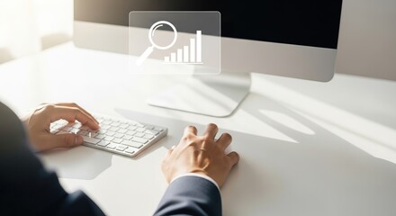 A person working on a computer, focusing on data analysis with a keyboard and monitor displaying performance metrics.