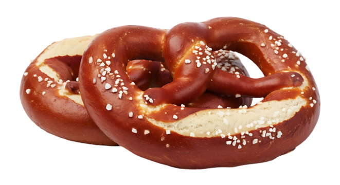 Two deliciously baked soft pretzels with coarse salt sprinkled on top against a black background