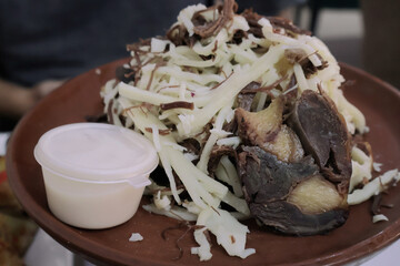 Traditional Kazakh beshbarmak with horse meat, noodles, and kurt sauce