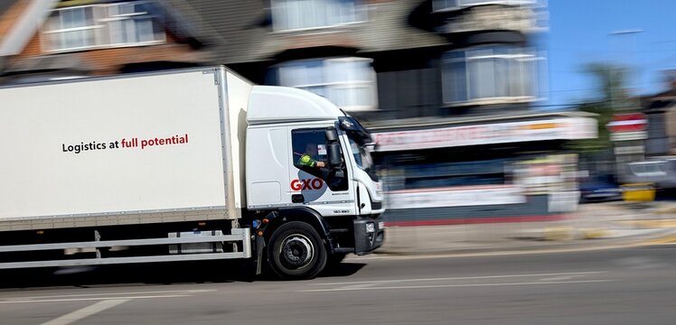 Leicester, England, UK - 13 May 2025: GXO Logistics. Fast-moving white delivery truck with motion blur
