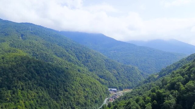 A cable car ride high up in the mountains with beautiful summer scenery.