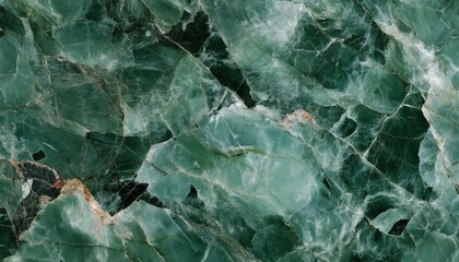 The image shows a detailed close-up of a green marble surface exhibiting a complex network of veins and cracks, revealing its natural texture.